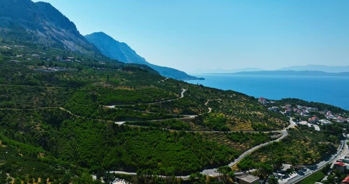 Aerial view of a winding road in the mountains of Makarska riviera in sunny Croatia