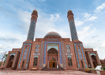 Fototapeta premium Goy Imam Mosque with its twin minarets and detailed mosaics graces a clear blue sky in Ganja, Azerbaijan