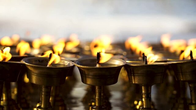 closeup view of burning earthern lamp in Baudhanath Stupa, Nepal.