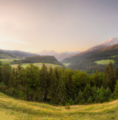 Meadow with road and bench during sunset in Berchtesgaden National Park