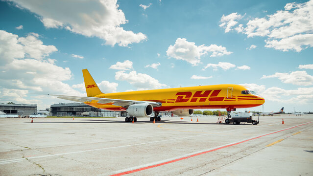 DHL cargo Boeing 757 (D-ALED) parked on apron; three quarter view of the yellow aircraft. Boryspil International Airport, Ukraine - May 22 2015.