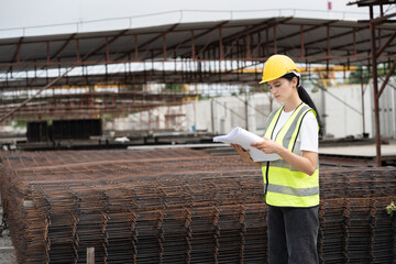 Portrait Hispanic latin engineer woman use paper work at precast cement outdoor factory	