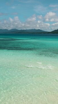 Seascape with tropical sandy beach and blue ocean. Balabac, Palawan. Philippines.