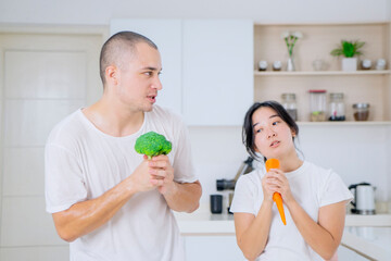 Married couples spend a few tender minutes before staring their workday. Sharing, laughing, teasing, serving each other loaf and beverage, Mutual understanding, sympathy and a supportive life partner