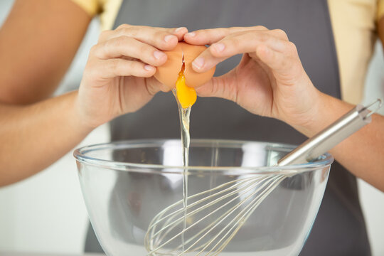 woman hands holding a bowl before beating eggs