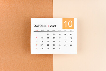 October 2024 calendar page on yellow background.