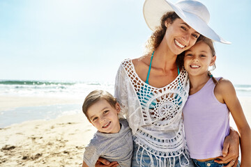 Portrait, hug or mother and children at a beach for summer, fun and bonding in nature together....