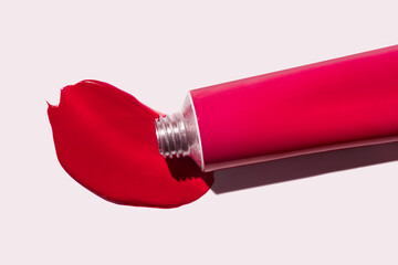 Hair due red fuchsia pigment swatch, lipstick, eye shadow, blush smudge swatch with metal tube on...