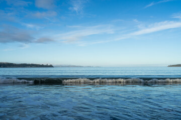 beautiful waves rolling in on a sandy beach in winter in Tasmania Australia