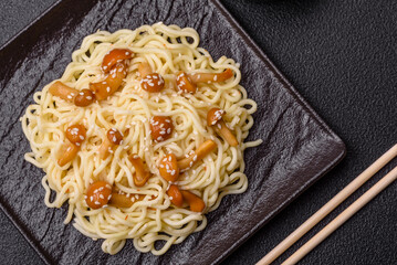Delicious Asian cuisine dish with rice noodles, peppers, mushrooms and spices