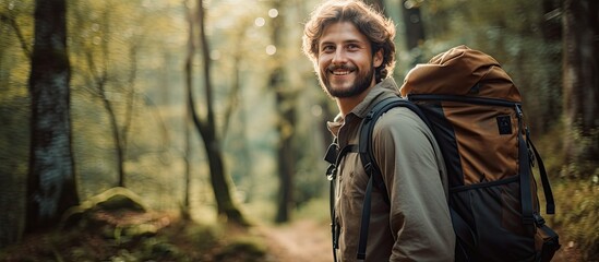 Obraz premium Asian hiker on mountain peak, legs and camera visible, holding a water bottle, smiling, scenic view behind, space for text or image. Copy space image. Place for adding text and design