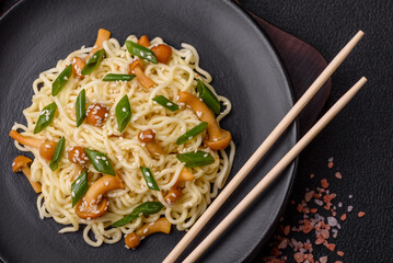 Delicious Asian cuisine dish with rice noodles, peppers, mushrooms and spices