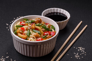Delicious Asian cuisine dish with rice noodles, peppers, mushrooms and spices