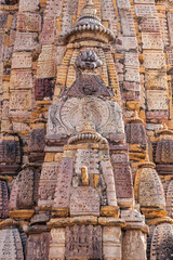 Ancient architectural stone carvings of Mandakini Temple with intricate artistry and historical...