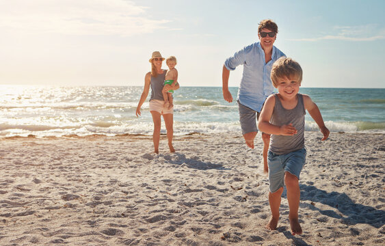Happy, people and children playing on the beach on family vacation, holiday or adventure in summer. Boy, father and kids chase with Miami ocean for fun energy and happiness with race running game