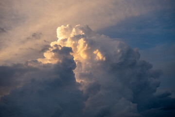 Large bad weather cloud with sunlight in background before thunderstorm