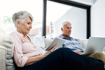 Laptop, tablet and senior couple on sofa reading news on internet for political election. Relax, research and elderly man and woman on computer and digital technology to register for voting at home.