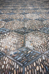 symetrical repeating pattern of pebbles and stones in a pathway hexagonal and diamond shapes