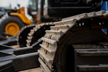 Construction excavator metal tracks close up in big construction project