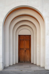 A plain door framed by a series of minimalist arches, each arch slightly larger than the one before, creating a sense of depth and perspective. The background remains solid and neutral