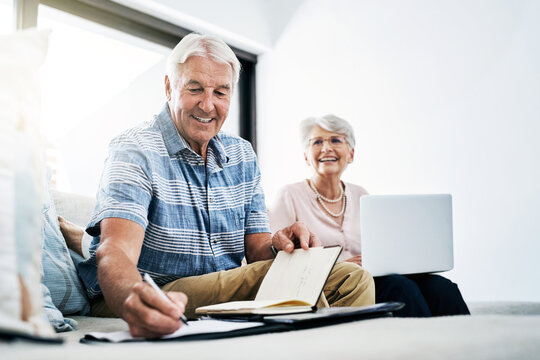 Laptop, writing and senior couple in home planning for retirement fund, savings and asset management. Online, computer and elderly man and woman with budget notes for bills, mortgage and debt payment
