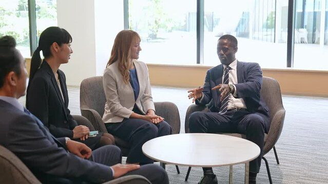 Group of multinational business people having a conversation in a lobby