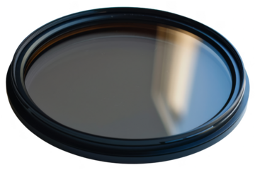 A black camera lens filter isolated on a white background.