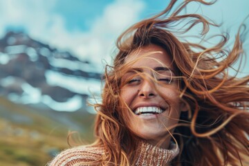 Woman Artistic. Carefree Woman with Flying Hair Laughing in Windy Mountain Landscape