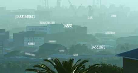 Image of numbers and data processing over cityscape