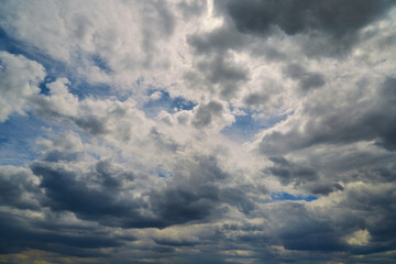 Obraz premium Gray clouds in blue sky close-up, cluster of clouds blocking sunlight