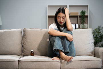 Fototapeta premium woman sit Depression Dark haired pensive glance Standing by window on sofa and anxiety