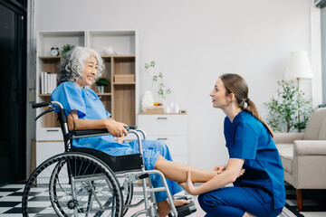 Physiotherapist helping elderly man patient stretching arm during exercise correct with dumbbell in...