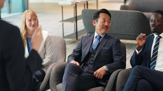 Group of multinational business people listening to a speech