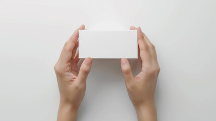 hand holding a blank white box on white background
