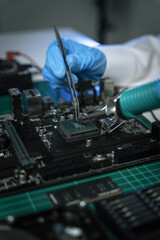 Hands repairing electronic devices. Electronic technician.