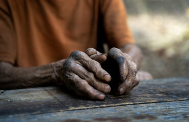 Close up of elderly oldman hands on wooden table.