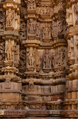 Beautiful Sculptures and carved on the wall of Chitragupta Temple in the Khajuraho temple complex, India