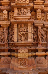 Ancient sculptures carved on the wall of Lakshmi Temple in the Khajuraho temple complex, India