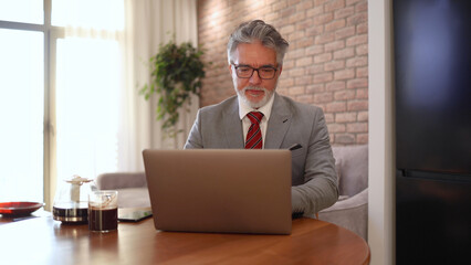 Mature businessman working online from his home office