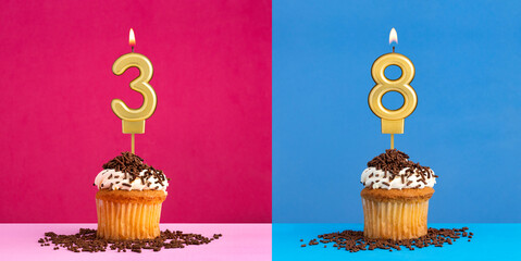 Two birthday cupcakes with the number 3 and 8 - Blue and pink background