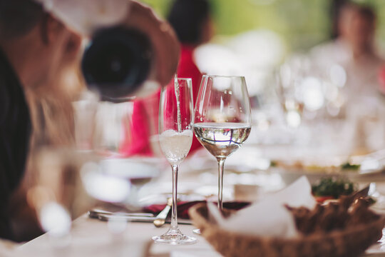 Restaurant and bar alcohol menu. Luxury drink. Banquet service outdoor.  Waiter brings glasses of wine and champagne.