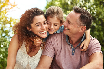 Fototapeta premium Happy, family and child hug outdoor with bonding, care or support for security trust together in backyard. Smile, woman and man or kid embrace moment, love and sunshine vacation of childhood memory