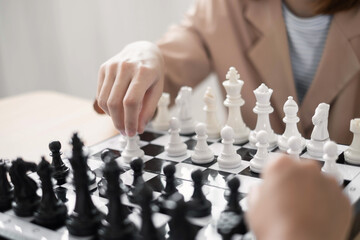 hand of businesswoman moving chess in competition shows leadership, followers and business success...