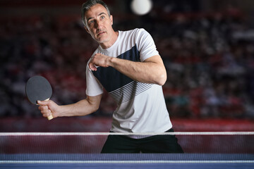 Ping-pong player receiving a ball in a competition with stands
