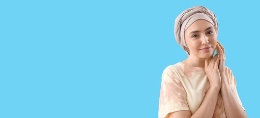 Young woman after chemotherapy on blue background with space for text