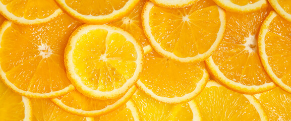 Many fresh orange slices as background, top view