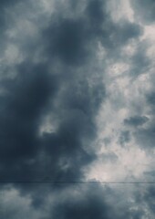 Impending Storm: Dark Cloudscape with Ominous Overcast Sky and Lone Wire