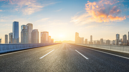 Fototapeta premium Asphalt highway road and city skyline with modern buildings at sunrise in Chongqing. Panoramic view.