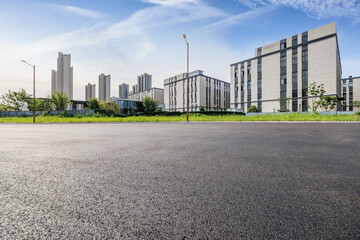 Asphalt road square and factory buildings background