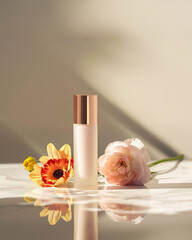 cosmetic product on a marble surface with flowers and light shadows. modern and stylish